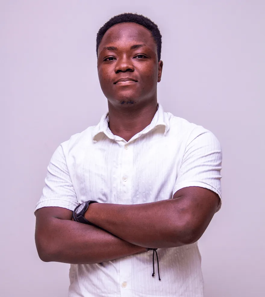 Daniel Sarpong, arms crossed, in a white shirt